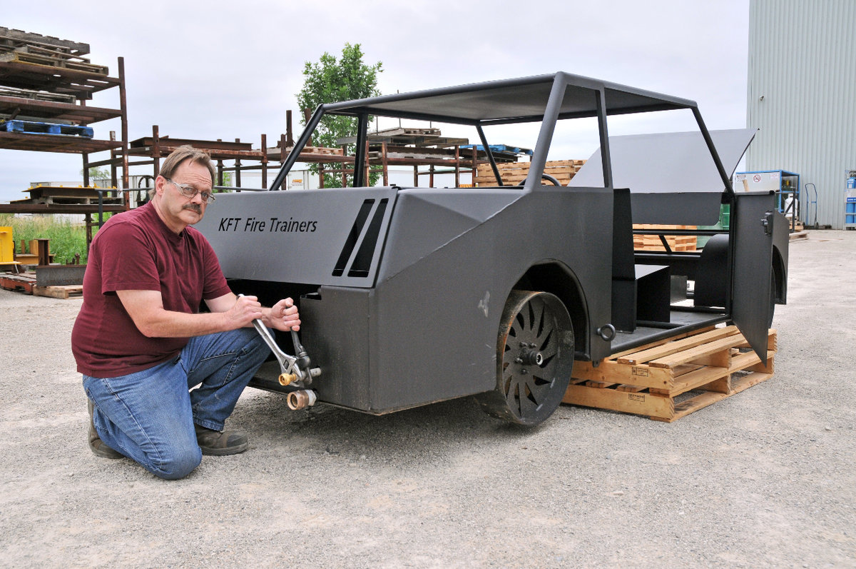 Man adjusting KFT Fire Training vehicle